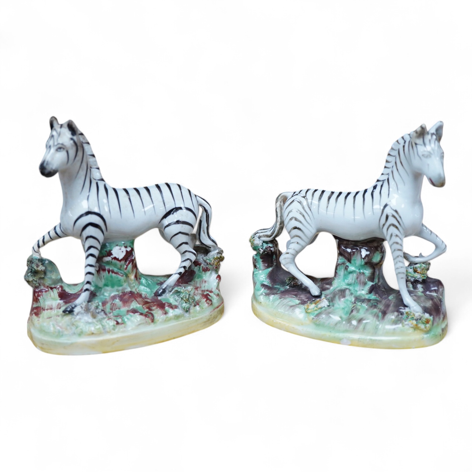 A pair of mid 19th century Staffordshire pottery models of Zebra, 12.5cm high